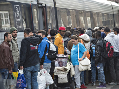 Immigrants trying to get on a train to Sweden