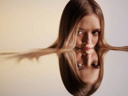 The mirror becomes a portal as she gazes upon her reflection, it mirrors her inner thoughts and dreams, echoing the essence of surrealism