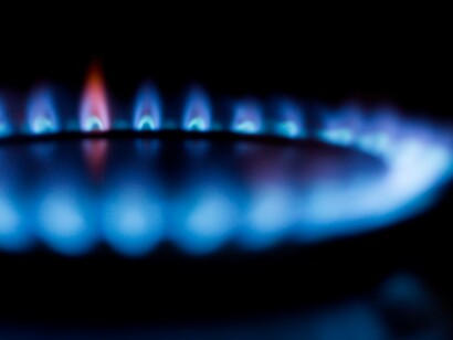 A closeup of a lit gas stove on a low level mirroring the low supply in Europe 