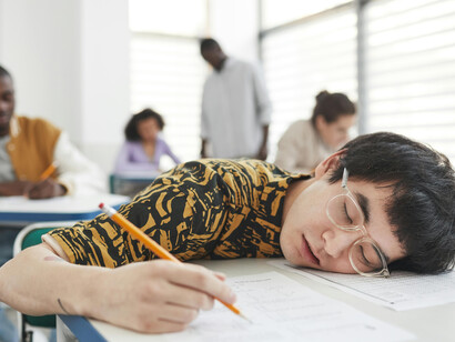 A student asleep at his desk during an examination
