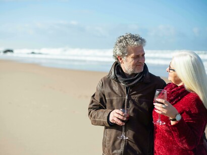 A senior couple strolling by the sea, staying active and maintaining their well-being