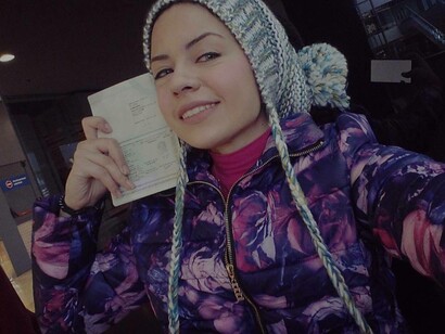 Hiba with her travel document expressing joy at it being her eureka moment