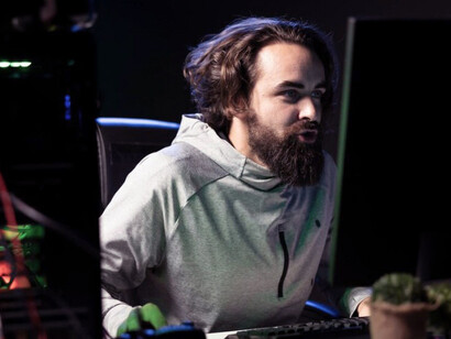 Man focused on competitive gaming while streaming a live tournament