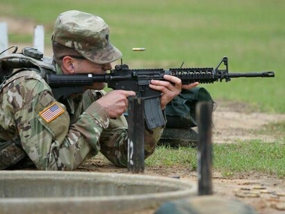 US soldier firing off a military-issued weapon