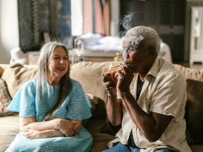 A couple smoking a cannabis joint together