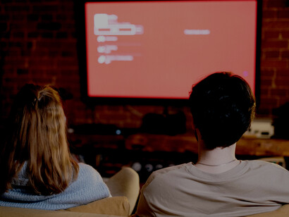 A happy couple playing video games together, strengthening their connection through a shared hobby