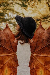 Leaves being used as wings to creatively give the person the power of flight