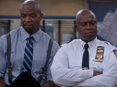 The humorous reaction of Captain Holt and Terry in Brooklyn Nine-Nine, symbolising the comfort found in predictable narratives