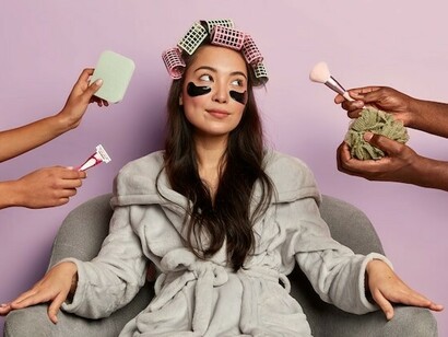 A woman relaxing in a spa robe with under-eye patches, reflecting beauty standards shaped by social media filters and cosmetic trends
