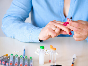 Insulin injection pen for diabetes treatment alongside medical syringes and handheld injection equipment