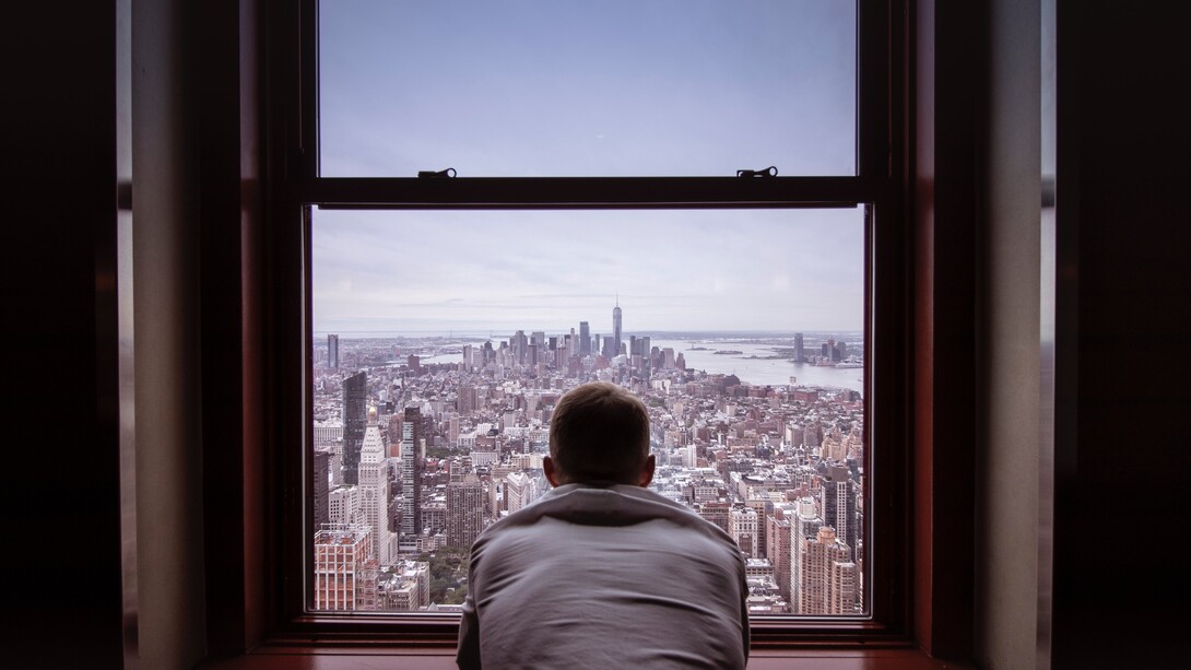 A person sat looking out of a building. Self-talk can be as varied and complex as our own personalities