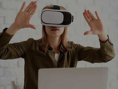 With VR glasses, a woman adeptly incorporates technology into her work routine, highlighting the growing dependence on cutting-edge tools in modern workplaces