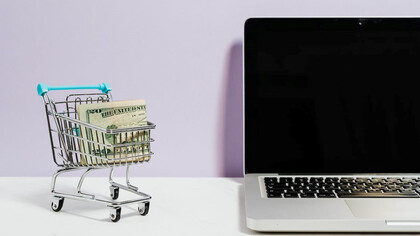 Next to a notebook, there is a miniature trolley