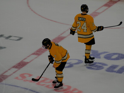 Full-gear ice hockey players competing fiercely on the ice