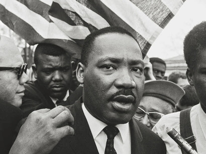 Steve Schapiro, Martin Luther King Jr. with flag during the Selma March, 1965. Courtesy of Camera Work Gallery