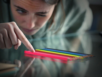 A woman obsesses by counting colour pencils. According to the American Psychological Association, OCD is “a disorder characterized by recurrent intrusive thoughts (obsessions) that prompt the performance of neutralizing rituals (compulsions)