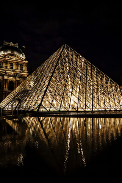 Paris, France, the Louvre Museum glowing after dark