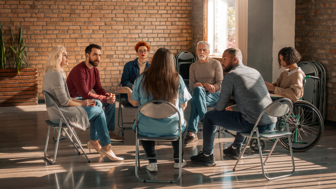 Members of a support group share their stories, fostering a safe space to combat the isolation often caused by depression