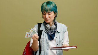 Image of a young female, adorned with headphones, a bandana around her neck, and a backpack, holding a notebook and money, symbolizing the struggles of economic inequality and financial disparity