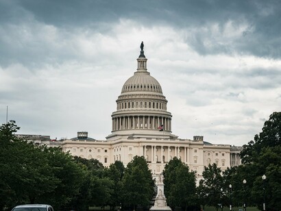 Dark clouds gathering over the Capitol, symbolizing the spiritual crisis confronting the United States