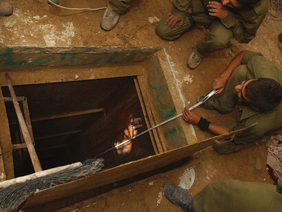 IDF soldiers measure a newly discovered tunnel concealed near a Palestinian family’s home