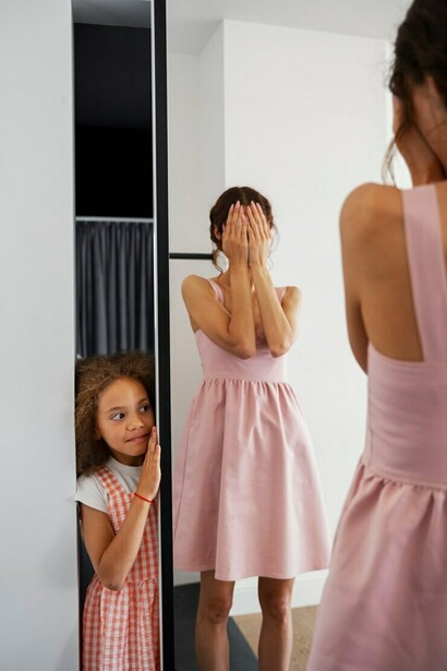 A parent gazing into the mirror with their child, seeing love and understanding reflected back