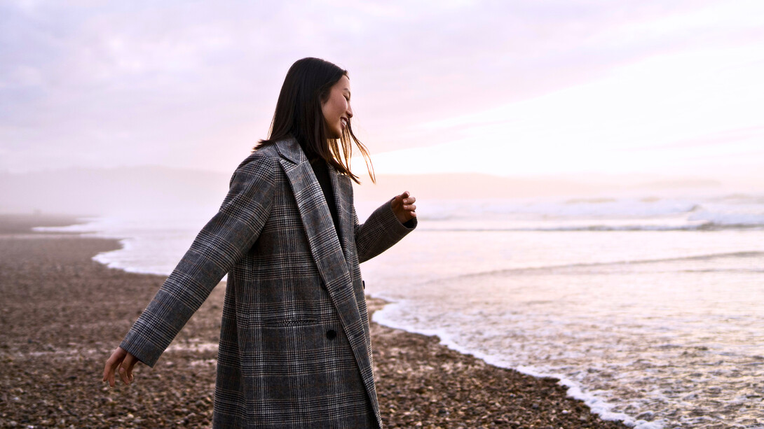 A woman enjoying the beach alone, showing that solitude can feel freeing
