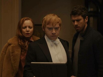 Rupert Grint (center) and Lauren Ambrose in a scene from Servant