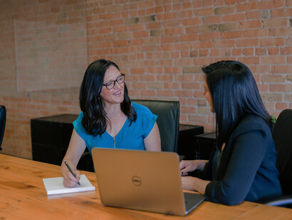 Two businesswomen talking; ask the right question and be empathetic