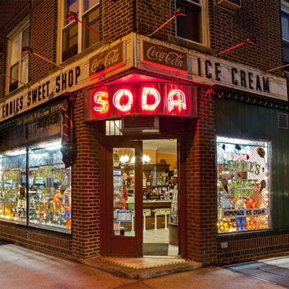 A vintage inspired New York City soda shop with a red neon sign reading "Soda"