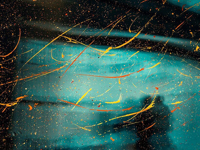 Harmony of elements, person's silhouette amidst green and yellow water droplets on glass