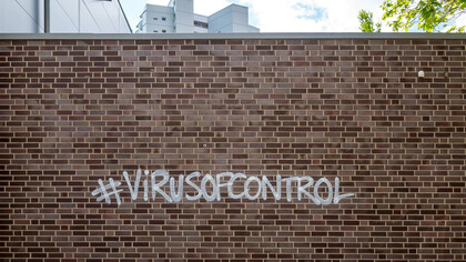 Virus of control written on a wall
