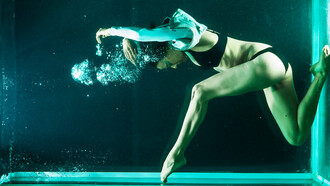 Experience the fitness revolution with a flexible woman gracefully dancing underwater—an invigorating exercise promoting holistic health and well-being