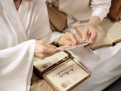 A couple exploring a collection of old letters, reflecting the role of letters in safeguarding personal histories