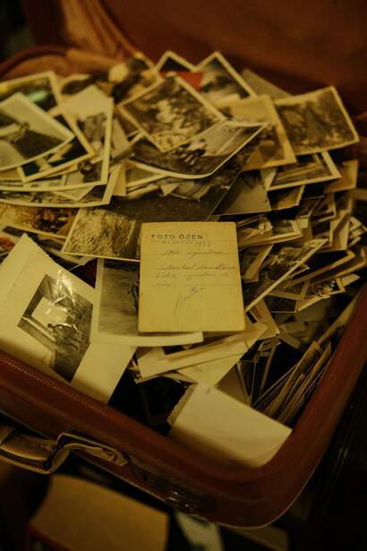 A vintage suitcase holding a collection of old photographs