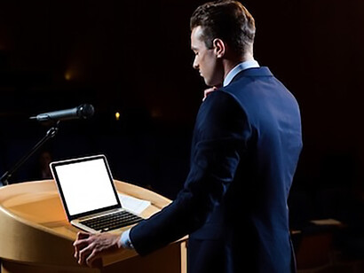 The charismatic male politician passionately addresses the audience, underscoring the crucial role of eloquence and communication prowess in effective leadership