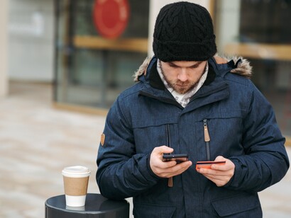 A man paying for something electronically using his phone 
