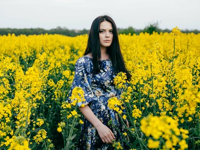 A woman resting in stillness among wildflowers, representing the serenity of a healed love identity