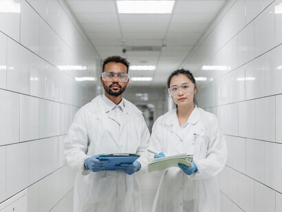 A man and woman walk down a hallway in a modern innovation lab, where scientists work together on research and development