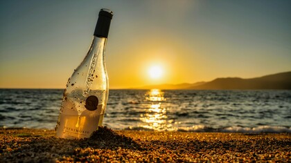 Wine on the sand, under the setting sun—the perfect beginning to a nostalgic and intimate night