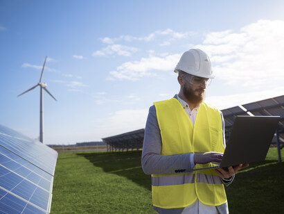 An engineer checks his laptop
