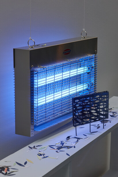 Charlie Godet Thomas, The Poet Preparing Traps, 2019. Acrylic on paper, cut painted card fragments, wood, commercial insect light. 69 x 180 x 18 cm. Photographer Jonathon Bassett.