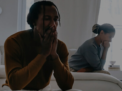 In a poignant tableau, an unhappy couple shares a moment of quiet discontent on a bed, emphasizing the crucial role of effective communication in addressing emotions and fostering mutual understanding to strengthen their relationship