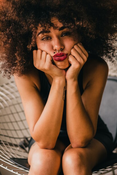 A woman sitting down, sad and crying to herself, with a negative attitude