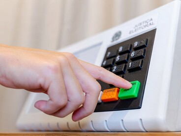 A voter confirms their choice on an electronic voting machine in Brazil’s presidential elections