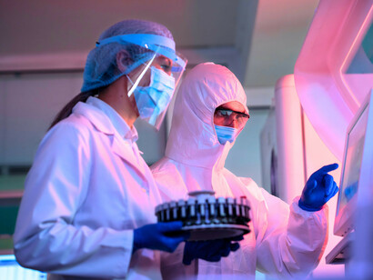 Laboratory specialists studying collected samples, symbolizing the careful testing used to evaluate the complex properties of human milk