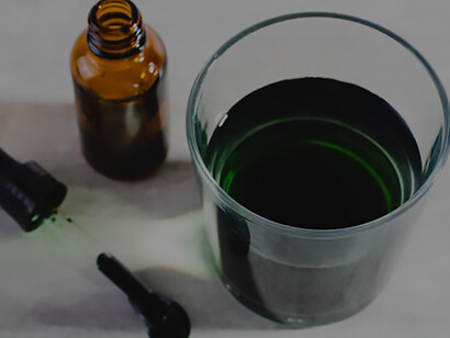 Glass of water with liquid chlorophyll, illustrating superfood, healthy eating, and detox concept