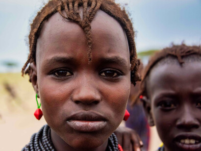 This Kisii child’s unwavering stare captures the essence of youthful curiosity and the strength found in their cultural roots