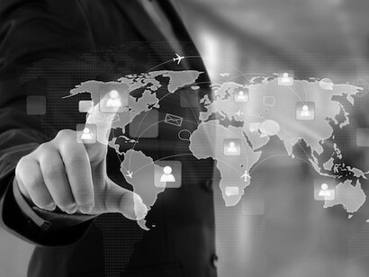 Businessmen interacting with a virtual world map illustrate how multinational corporations drive global trade, economic growth, and technological innovation through international business and strategic investment