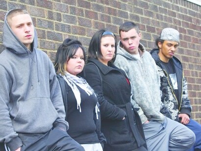 A teenage street gang, being intimidating and looking into a camera
